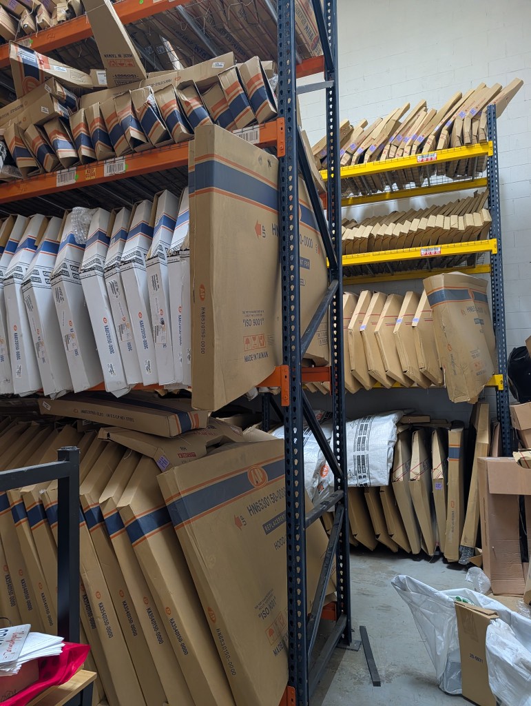 Agro Capital US warehouse aisle with stacked equipment boxes