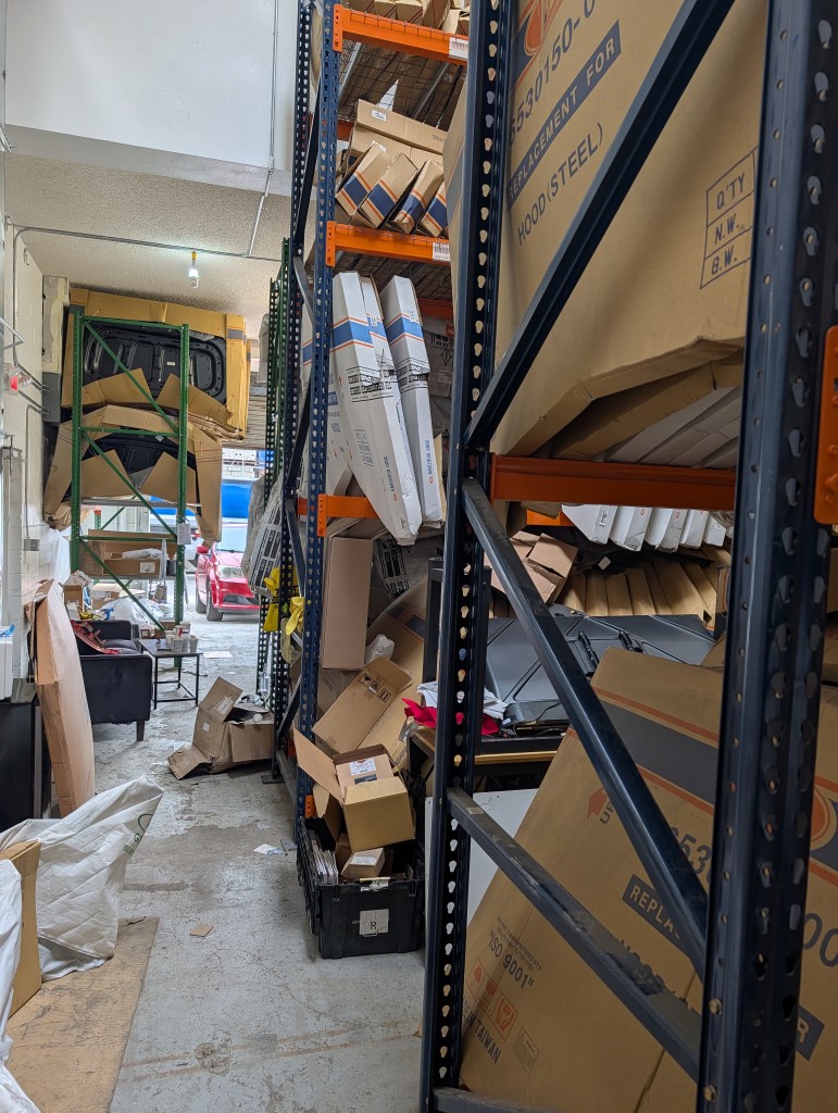 Boxed parts and machinery components arranged on warehouse racks